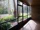 Screened porch overlooking a lush green landscape at 130 Jasmine Woods Ct # 15C, Deltona, FL 32725