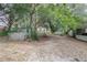 Partially fenced backyard with mature trees at 1579 Dunlap Dr, Deltona, FL 32725