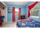 Cozy bedroom with a full-size bed and red curtains at 1579 Dunlap Dr, Deltona, FL 32725