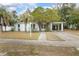 White ranch home with palm trees and a carport at 1579 Dunlap Dr, Deltona, FL 32725