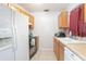 Galley style kitchen with white appliances at 1579 Dunlap Dr, Deltona, FL 32725