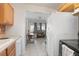 Kitchen with wood cabinets and view of sunroom at 1579 Dunlap Dr, Deltona, FL 32725