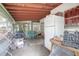 Enclosed porch with a refrigerator and workbench at 1579 Dunlap Dr, Deltona, FL 32725