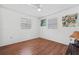 Bright bedroom with wood floors, ceiling fan, and two windows at 1701 N Stone St, Deland, FL 32720