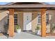 Front entrance with wooden pillars and white door at 1701 N Stone St, Deland, FL 32720