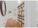 Hallway with built-in storage and hardwood floors at 1701 N Stone St, Deland, FL 32720
