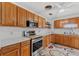 Kitchen with wood cabinets, stainless steel appliances, and white countertops at 1701 N Stone St, Deland, FL 32720
