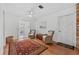 Living room with hardwood floors, wicker chairs, and a red rug at 1701 N Stone St, Deland, FL 32720