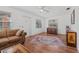 Cozy living room featuring hardwood floors, a ceiling fan, and ample natural light at 1701 N Stone St, Deland, FL 32720