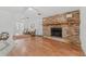 Living room with brick fireplace and hardwood floors at 1701 N Stone St, Deland, FL 32720