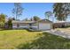 Front view of a house with a spacious yard and driveway at 1768 Santee Ave, Deltona, FL 32738