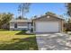 One-story house with attached garage and well-maintained lawn at 1768 Santee Ave, Deltona, FL 32738