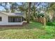 House backyard with lush landscaping and wooden fence at 2 Rollingwood Trl, Deland, FL 32724