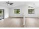 Bright living room with vaulted ceiling, hardwood floors, and a half wall at 2 Rollingwood Trl, Deland, FL 32724