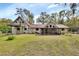 Expansive backyard view showing a multi-story home with a screened-in porch and upper deck, perfect for outdoor living at 2170 Wilmhurst Rd, Deland, FL 32720