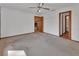 Spacious bedroom with ceiling fan, wood trim and fireplace view to another room at 2170 Wilmhurst Rd, Deland, FL 32720