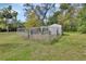 Backyard dog run featuring a chain-link fence and small shelter providing a secure space for pets to roam at 2170 Wilmhurst Rd, Deland, FL 32720