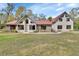 Charming home with a red roof, light siding, brick accents and an expansive front lawn at 2170 Wilmhurst Rd, Deland, FL 32720