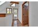 Hallway with tile flooring leading to an exterior door and connecting spaces at 2170 Wilmhurst Rd, Deland, FL 32720