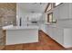 Well-lit kitchen with white cabinets, tiled floor, counter space, and essential appliances at 2170 Wilmhurst Rd, Deland, FL 32720