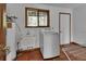 Laundry room with a utility sink and washer, along with an exterior door at 2170 Wilmhurst Rd, Deland, FL 32720