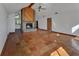 Open-concept living room with brick fireplace, tile floors, and lots of natural light at 2170 Wilmhurst Rd, Deland, FL 32720