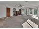 Living room featuring carpet, a ceiling fan, and double doors leading outside at 2170 Wilmhurst Rd, Deland, FL 32720