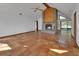 Open-concept living room featuring tile flooring, a brick fireplace, and bright, airy space at 2170 Wilmhurst Rd, Deland, FL 32720