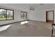 Bright living room with carpet, ceiling fan, natural light, and minimalist decor at 2170 Wilmhurst Rd, Deland, FL 32720