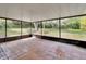 Spacious screened porch with tile flooring and clear views of the wooded backyard at 2170 Wilmhurst Rd, Deland, FL 32720