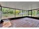 Screened porch that has tile flooring and a view of the backyard at 2170 Wilmhurst Rd, Deland, FL 32720