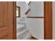 Carpeted staircase with wooden banister and trim, leading to the upper level of the home at 2170 Wilmhurst Rd, Deland, FL 32720