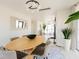 Bright dining room with large table, chairs, and modern light fixture at 2200 N Atlantic Ave # 1502, Daytona Beach, FL 32118