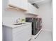 Bright laundry room with modern washer, dryer, and ample cabinetry at 2200 N Atlantic Ave # 1502, Daytona Beach, FL 32118