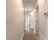 Bright hallway with hardwood floors and doors to bedrooms at 2472 Duval Ave, Deltona, FL 32738