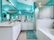 Double vanity bathroom with teal colored walls at 2508 Balmoral Dr, Kissimmee, FL 34744