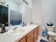 Bathroom with double sinks, shower, and toilet at 2508 Balmoral Dr, Kissimmee, FL 34744