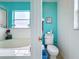 Bathroom with toilet, bathtub, and teal colored walls at 2508 Balmoral Dr, Kissimmee, FL 34744