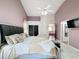 King-size bed in a well-lit bedroom with a ceiling fan at 2508 Balmoral Dr, Kissimmee, FL 34744