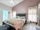 Primary bedroom with king bed and ensuite bathroom access at 2508 Balmoral Dr, Kissimmee, FL 34744