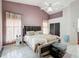 Bright bedroom with a king-size bed and window coverings at 2508 Balmoral Dr, Kissimmee, FL 34744