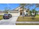 House exterior featuring a two-car garage and manicured lawn at 2508 Balmoral Dr, Kissimmee, FL 34744