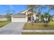 Inviting one-story home with a landscaped lawn and attached garage at 2508 Balmoral Dr, Kissimmee, FL 34744