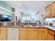 Kitchen island with granite countertop, sink, and views of the living area at 2508 Balmoral Dr, Kissimmee, FL 34744