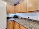 Kitchen corner with granite countertops and wood cabinets at 2508 Balmoral Dr, Kissimmee, FL 34744