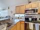 Kitchen with granite countertops, stainless steel appliances and wood cabinets at 2508 Balmoral Dr, Kissimmee, FL 34744