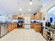 Bright kitchen boasting granite counters, wood cabinets & stainless steel appliances at 2508 Balmoral Dr, Kissimmee, FL 34744
