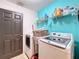 Laundry room with washer, dryer, and storage shelves at 2508 Balmoral Dr, Kissimmee, FL 34744