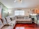 Open concept living room with sectional sofa and hardwood floors, adjacent to kitchen at 2508 Balmoral Dr, Kissimmee, FL 34744