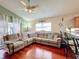 Bright living room features hardwood floors, a sectional sofa, and an open concept to kitchen at 2508 Balmoral Dr, Kissimmee, FL 34744